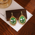 Detailed view of French vintage green oval cameo earrings with white floral pearl accents - Gold Edge Green Flower Bud Relief (E6201-1)