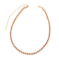 Gold plated tennis necklace featuring red round cubic zirconia stones and heart charm - Rose Red