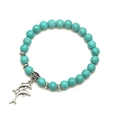 Bohemian turquoise beaded bracelet featuring silver dolphin charms on a white background - Dolphin