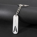 Minimalist silver metal keychain with hollow capital letter A pendant on black background - Letter A