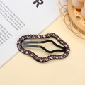 Detail of wavy black metal hair clip decorated with sparkling pink rhinestones - Purple Cloud