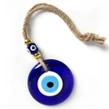 Detail view of a round blue glass Evil Eye pendant with jute rope and beaded accents - 8CM Pendant - 3 Beads Style