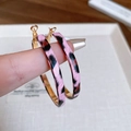 Close-up of pink leopard print hoop earrings with gold inner finish held by hand - Pink Leopard Hoop Earrings / Gold Pink (15# Silver Needle)