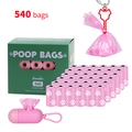 Detail view of 540 biodegradable pink dog poop bags with dispenser and green storage box - Boxed with Dispenser and Clip / 36 Rolls / Pink