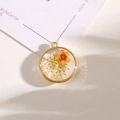 Handmade round golden alloy pendant featuring orange and yellow dried flowers in resin - Style 16