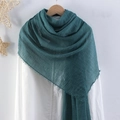 Deep green crinkled cotton linen scarf with frayed edges hanging on a wooden hanger - Dark Green