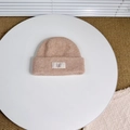 Detailed view of beige wool knit beanie featuring a white BAKE fabric label on the cuff - Approx. 3-8 Years / Beige