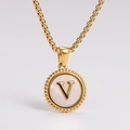 Macro shot of gold necklace featuring a round pendant with mother of pearl and V letter - Letter V