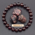 Macro view of natural garnet bead bracelet with raw unpolished stones on dark background - Natural Garnet