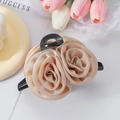 Detail shot of the champagne fabric rose hair claw clip with elegant satin texture finish - Champagne