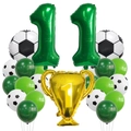 Detail of football party kit featuring golden champion trophy and green number 11 balloons - Number Eleven Theme