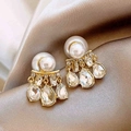 Detailed macro view of gold plated bow earrings with large white pearls and crystal drops - 79# Silver Earring Post - Gold - White - Teardrop
