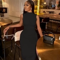Elegant woman in a black sleeveless turtleneck midi dress with fine pleated textures - S / Black