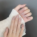 Close-up of nude pink trapezoidal fake nails with shell flakes and silver accents - By1762 Refined And Profound / Phototherapy Glue Style