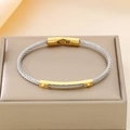 Two-tone silver cable bangle with gold center bar on a beige jewelry display stand - Stainless Steel Silver Cable Gold Trim Bracelet (KB183060-HB)