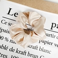 Champagne satin oversized scrunchie with pearl sheen on minimalist background - Satin Champagne Gold