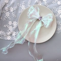 Detail of white organza bow hair clip with silver edges and purple gemstone center - 1224 Iridescent White with Diamonds