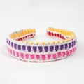 Handmade knitted floral headband with pink, purple and yellow stripes on white base - Plaid