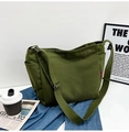 Detail of olive green canvas bag with side pockets and adjustable strap on denim - Without Pendant / Army Green