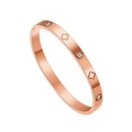 Detailed macro view of a rose gold stainless steel bangle with clover motifs and sparkling zircons - Rose Gold