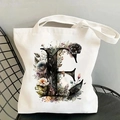 Detail of floral letter E print on cream canvas tote bag resting on a black mesh chair - Letter E / 35*40cm