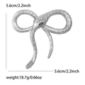 Detail view of silver snake brooch with blue gem eyes and dimensions 5.6cm and 18.7g - Blue Eyes/Silver Snake Body / Silver
