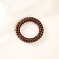 Detail of coffee brown spiral phone cord hair tie with a glossy metallic finish texture - Metallic Bronze (5cm Thick)