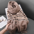 Women's plaid cashmere scarf with fringes in earthy tones on a stylish magazine backdrop - Brown