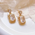 Luxurious gold-plated earrings featuring large rectangular zircon stones and pavé accents - White Zirconia Stud Earrings