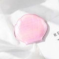 Pink shell-shaped compact mirror with glossy iridescent scale texture on fabric - Fish Scale Pink