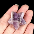 Star-shaped purple amethyst crystal stone accessory held in hand for jewelry DIY - Amethyst