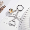 Silver airplane keychain bottle opener with a planetary glass pendant and metal ring - Jupiter Galaxy