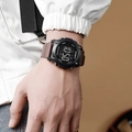 Detail of waterproof digital sports watch with brown rubber strap on wrist - Coffee