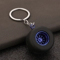 PVC car tire keychain featuring a realistic blue wheel hub and black rubber tire model - Blue