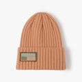 Knitted orange beanie hat with rib-knit texture and authentic woven label patch - One Size / Orange Red