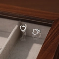 Minimalist S925 sterling silver hollow heart hoop earrings on a mirrored surface - Silver