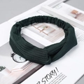 Deep green ribbed twist headband for yoga and skincare on a stylish magazine - Knitted Dark Green