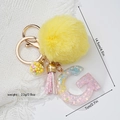 Star sequin resin letter G keychain with yellow pompom and tassel charm on white background - Letter G