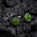 Macro shot of green round jade earrings set in S925 silver on a dark stone background - Natural Jasper Round Silver 5mm