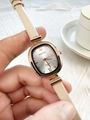 Close-up of elegant beige leather strap watch with rose gold square case and silver dial - Apricot