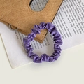 Elegant purple satin scrunchie with a glossy silk finish on a vintage magazine background - Grape Purple