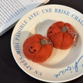 Handmade orange wool felt pumpkin keychains with happy faces in a white plate - Orange Pumpkin Pair
