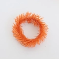 Macro shot of fluffy orange foil candle ring for Christmas wreath table decorations - 8cm Orange Tinsel Ring