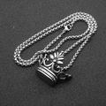 Detailed top-down view of a silver stainless steel crown pendant on a braided chain link - Style B Silver / 60cm Box Chain
