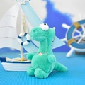 Detailed view of cute green plush dinosaur keychain with pink flower and bead chain - 14cm / Light Green