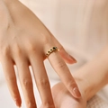Detail view of adjustable gold ring with heart-shaped green stones and micro-diamonds - Adjustable Open / Green (KR0044-1)