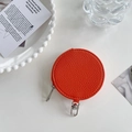 Detail view of orange textured leather coin purse with silver zipper and clasp hook - Orange Red