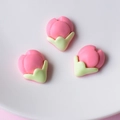 Three pink peach blossom resin charms for DIY crafts and hair accessories on a plate - Water Red Bud