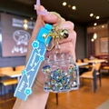 Acrylic castle keychain with blue strap and colorful star sequins inside charms - Black Luminous Bubble Bead Castle
