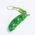 Green edamame squeeze toy with three beans and keychain strap for stress relief - Unpackaged Squeeze Edamame